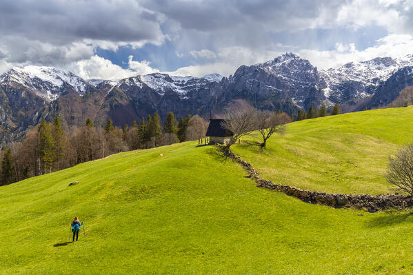 View of the small chapel of Pigolotta di Valtorta surrounded by meadows in spring. Valtorta, Bergamo province, Brembana valley, Lombardy, Italy, Europe.