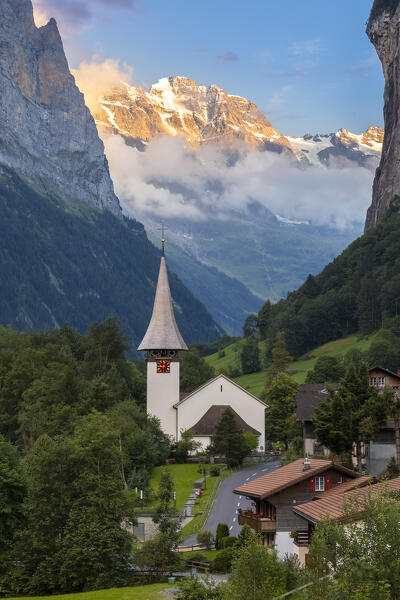 View of the small village of Lauterbrunnen at sunset in summer. Lauterbrunnen, Canton of Bern, Switzerland, Europe.
