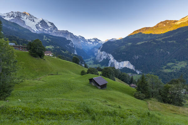 View of Lauterbrunnen valley from Wengen town in summer at sunrise. Wengen, Canton of Bern, Switzerland, Europe