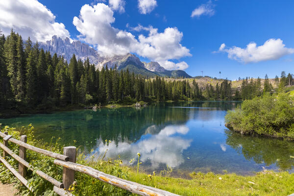 View of the Karersee lake in summer. Carezza, Dolomites, South Tyrol, Trentino Alto Adige, Italy. 