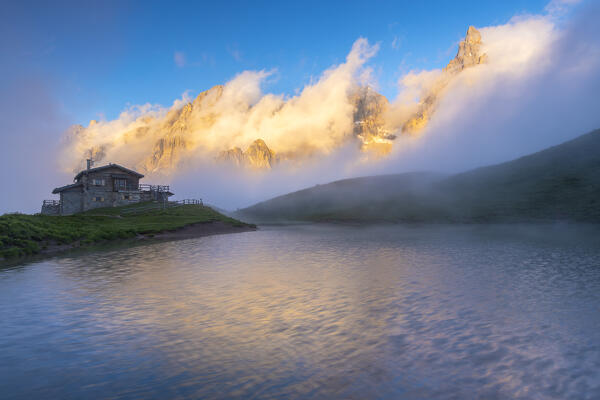 View of Baita Segantini refuge and Pale di San Martino at sunset in Dolomites. Trento province, Trentino Alto Adige, Italy, Europe.