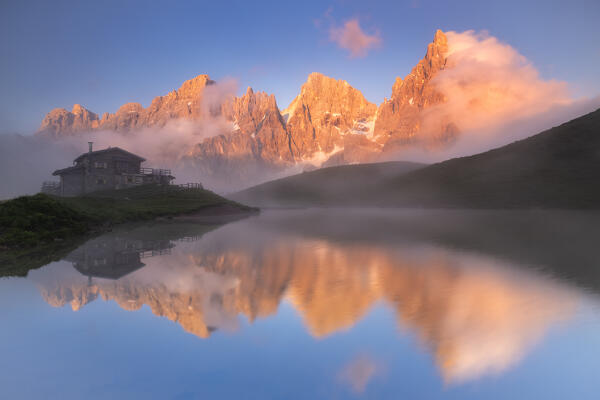 View of Baita Segantini refuge and Pale di San Martino at sunset in Dolomites. Trento province, Trentino Alto Adige, Italy, Europe.