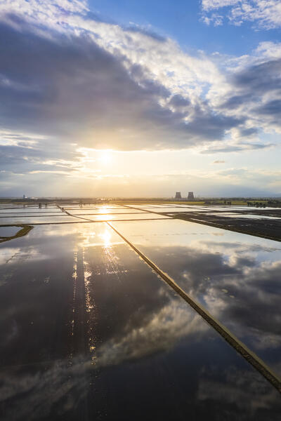 Aerial view of the flooded rice fields near the Principality of Lucedio at sunset. Trino Vercellese, Vercelli district, Piedmont, Italy.