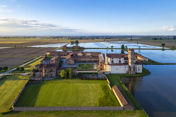Aerial view of the flooded rice fields near the Principality of Lucedio at sunset. Trino Vercellese, Vercelli district, Piedmont, Italy.