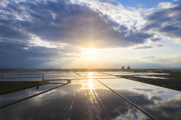 Aerial view of the flooded rice fields near the Principality of Lucedio at sunset. Trino Vercellese, Vercelli district, Piedmont, Italy.