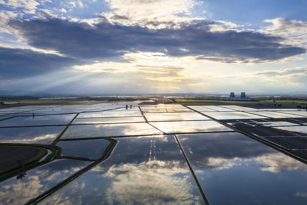 Aerial view of the flooded rice fields near the Principality of Lucedio at sunset. Trino Vercellese, Vercelli district, Piedmont, Italy.