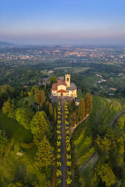 View of Santuario della Beata Vergine del Carmelo at the top of a hill at sunset in spring. Montevecchia, Lecco district, Lombardy, Italy.
