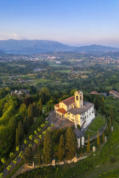 View of Santuario della Beata Vergine del Carmelo at the top of a hill at sunset in spring. Montevecchia, Lecco district, Lombardy, Italy.