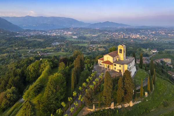 View of Santuario della Beata Vergine del Carmelo at the top of a hill at sunset in spring. Montevecchia, Lecco district, Lombardy, Italy.