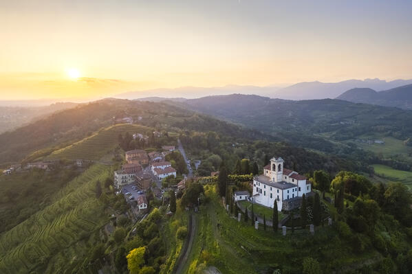 View of Santuario della Beata Vergine del Carmelo at the top of a hill at sunset in spring. Montevecchia, Lecco district, Lombardy, Italy.
