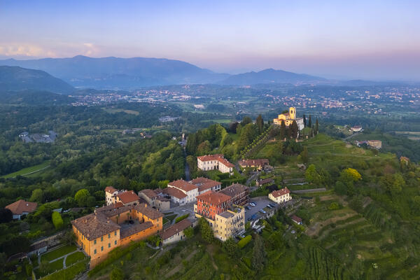 View of Santuario della Beata Vergine del Carmelo at the top of a hill at sunset in spring. Montevecchia, Lecco district, Lombardy, Italy.