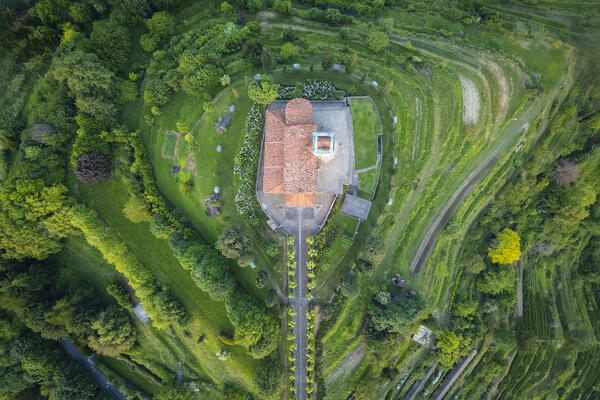 View of Santuario della Beata Vergine del Carmelo at the top of a hill at sunset in spring. Montevecchia, Lecco district, Lombardy, Italy.