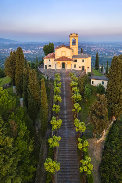 View of Santuario della Beata Vergine del Carmelo at the top of a hill at sunset in spring. Montevecchia, Lecco district, Lombardy, Italy.