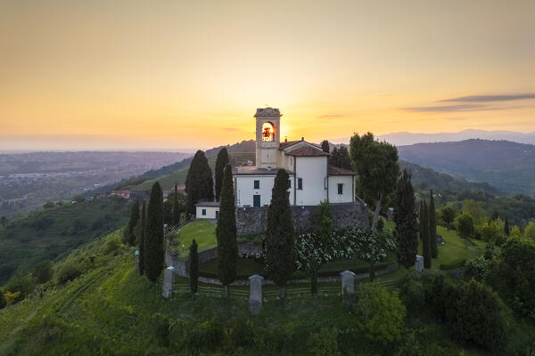 View of Santuario della Beata Vergine del Carmelo at the top of a hill at sunset in spring. Montevecchia, Lecco district, Lombardy, Italy.