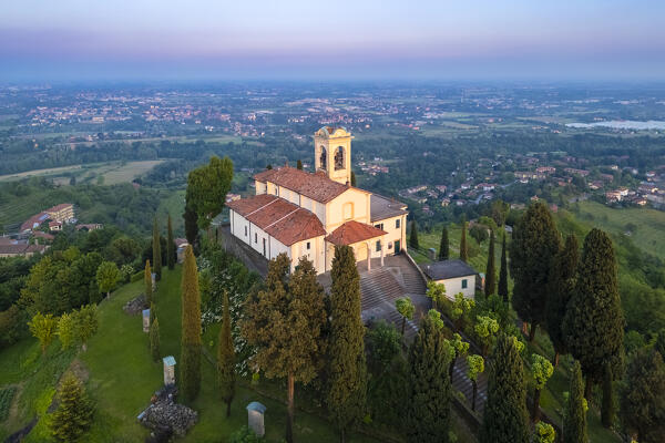 View of Santuario della Beata Vergine del Carmelo at the top of a hill at sunset in spring. Montevecchia, Lecco district, Lombardy, Italy.