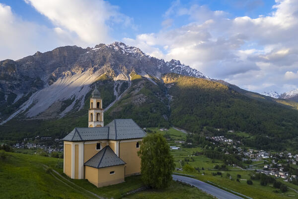View of a spring sunset over Bormio city from the church of Madonna di Oga. Bormio, Sondrio district, Valtellina, Lombardy, Italy, Europe.