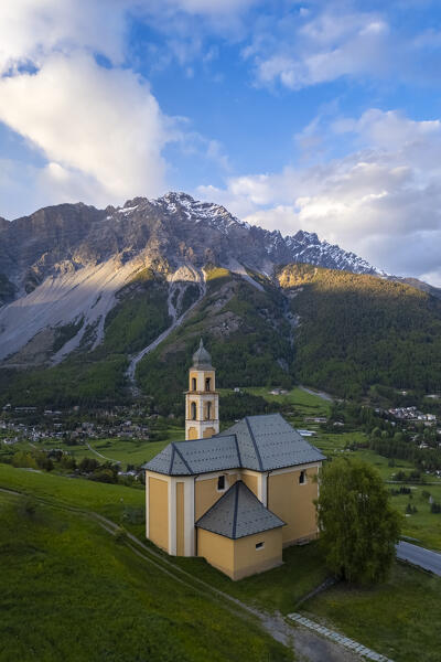 View of a spring sunset over Bormio city from the church of Madonna di Oga. Bormio, Sondrio district, Valtellina, Lombardy, Italy, Europe.
