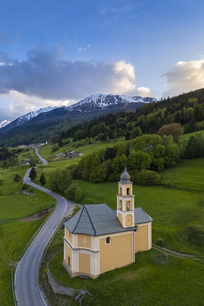 View of a spring sunset over Bormio city from the church of Madonna di Oga. Bormio, Sondrio district, Valtellina, Lombardy, Italy, Europe.