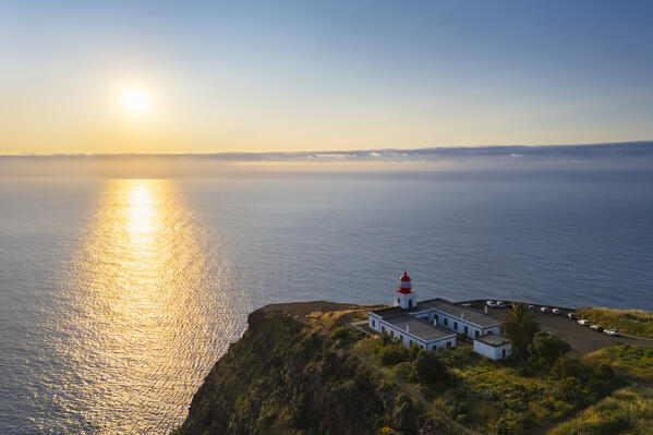 Aerial view of the amazing lighthouse called Farol da Ponta do Pargo at sunset in spring. Madeira, Portugal, Europe.