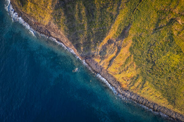 Aerial view of the cliffs below the amazing lighthouse called Farol da Ponta do Pargo at sunset in spring. Madeira, Portugal, Europe.