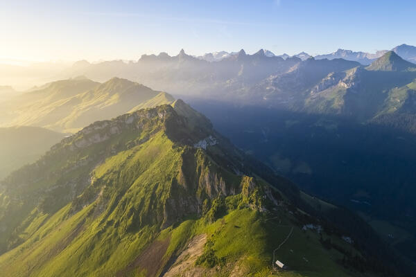 Aerial view of the trail on the crest leading from Klingenstock to Fronalpstock at sunrise. Stoos, Canton of Schwyz, Schwyzer Alps, Switzerland.