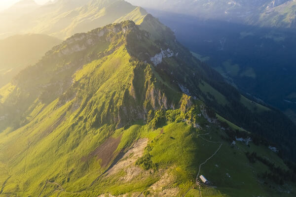 Aerial view of the trail on the crest leading from Klingenstock to Fronalpstock at sunrise. Stoos, Canton of Schwyz, Schwyzer Alps, Switzerland.