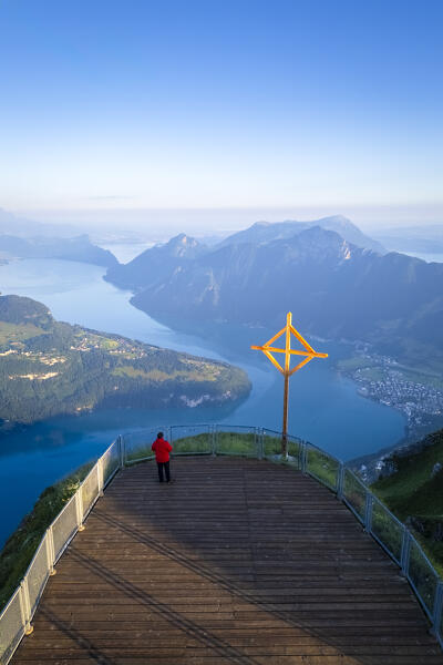 Aerial view of a tourist admiring dawn at the viewpoint of Fronalpstock. Stoos, Canton of Schwyz, Schwyzer Alps, Switzerland.