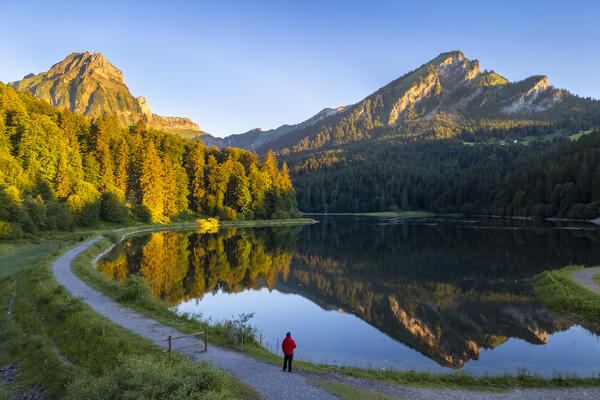 Aerial view of Barensoolspitz and Brunnelistock peaks at sunrise reflected in the Obersee lake. Näfels, Oberseealp, Canton of  Glarus, Switzerland.