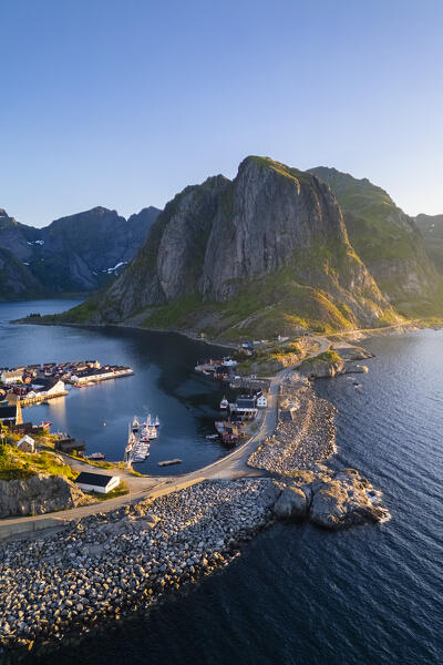 Aerial view of the Hamnøya island and the Lilandstinden mountain in Reine Bay during summer sunrise at midnight sun. Lofoten Islands, Norway.