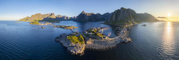 Aerial view of the Hamnøya island and the Lilandstinden mountain in Reine Bay during summer sunrise at midnight sun. Lofoten Islands, Norway.