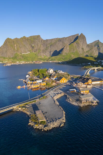Aerial view of the Sakrisøya island and Reine Bay towards Reinebringen in summer at sunrise during midnight sun. Lofoten Islands, Norway.