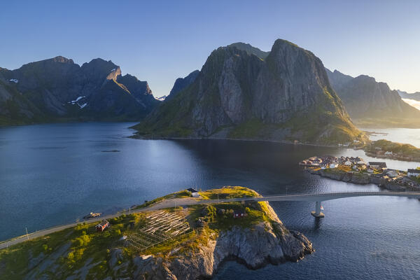 Aerial view of the Hamnøya island and the Lilandstinden mountain in Reine Bay during summer sunrise at midnight sun. Lofoten Islands, Norway.