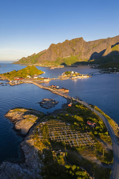 Aerial view of the Sakrisøya island and Reine Bay towards Reinebringen in summer at sunrise during midnight sun. Lofoten Islands, Norway.