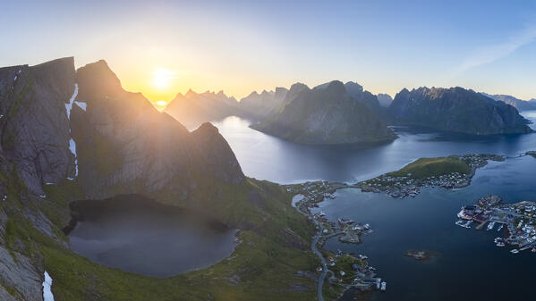 Aerial view at sunset of Reine Bay from the rocky peak of Reinebringen. Reine, Moskenes, Nordland, Lofoten Islands, Norway.