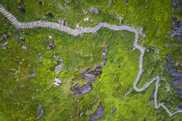 Aerial view at sunrise of the trail to the top of Reinebringen. Reine, Moskenes, Nordland, Lofoten Islands, Norway.
