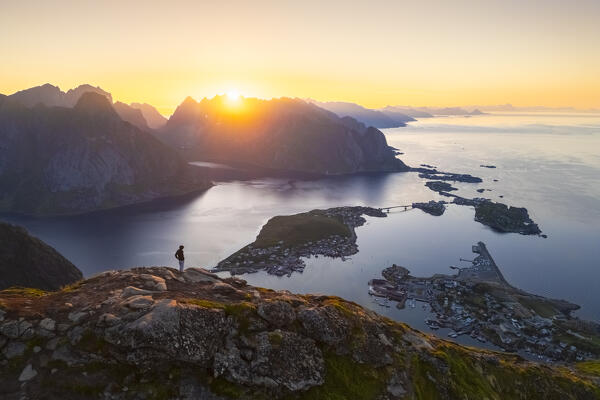 Aerial view of a sunrise at the top of Reinebringen mountain in summer during midnight sun. Reine, Moskenes, Nordland, Lofoten Islands, Norway.