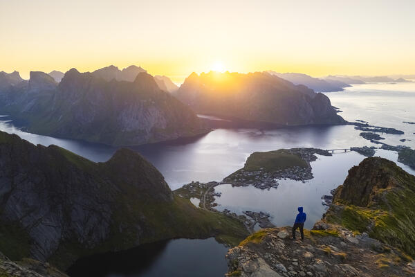 Aerial view of a sunrise at the top of Reinebringen mountain in summer during midnight sun. Reine, Moskenes, Nordland, Lofoten Islands, Norway.