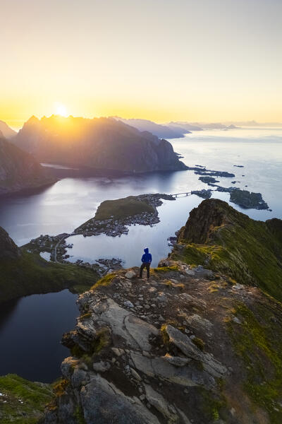 Aerial view of a sunrise at the top of Reinebringen mountain in summer during midnight sun. Reine, Moskenes, Nordland, Lofoten Islands, Norway.