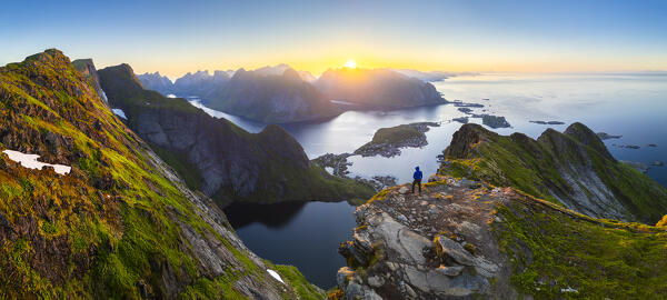 Aerial view of a sunrise at the top of Reinebringen mountain in summer during midnight sun. Reine, Moskenes, Nordland, Lofoten Islands, Norway.