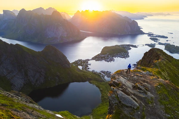 Aerial view of a sunrise at the top of Reinebringen mountain in summer during midnight sun. Reine, Moskenes, Nordland, Lofoten Islands, Norway.