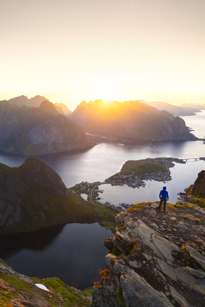 Aerial view of a sunrise at the top of Reinebringen mountain in summer during midnight sun. Reine, Moskenes, Nordland, Lofoten Islands, Norway.