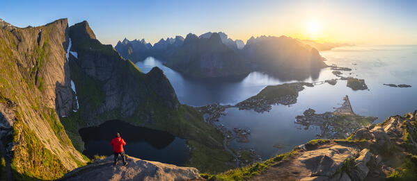 Aerial view of a sunrise at the top of Reinebringen mountain in summer during midnight sun. Reine, Moskenes, Nordland, Lofoten Islands, Norway.