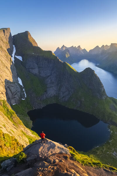 Aerial view of a sunrise at the top of Reinebringen mountain in summer during midnight sun. Reine, Moskenes, Nordland, Lofoten Islands, Norway.