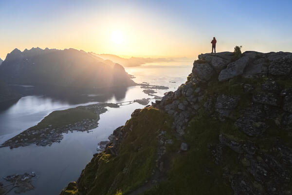 Aerial view of a sunrise at the top of Reinebringen mountain in summer during midnight sun. Reine, Moskenes, Nordland, Lofoten Islands, Norway.