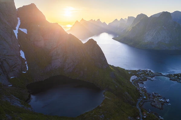 Aerial view of a sunrise at the top of Reinebringen mountain in summer during midnight sun. Reine, Moskenes, Nordland, Lofoten Islands, Norway.