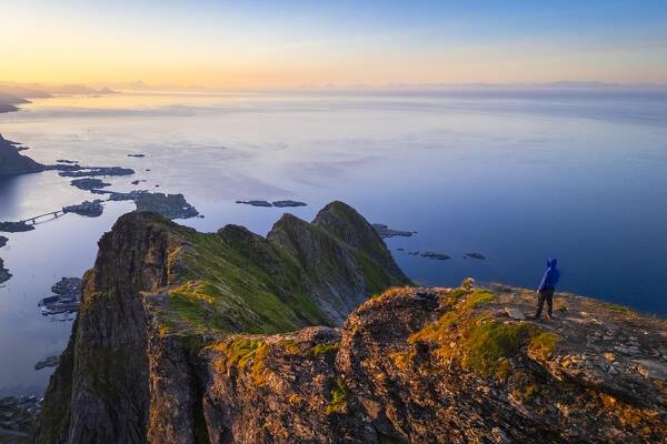 Aerial view of a sunrise at the top of Reinebringen mountain in summer during midnight sun. Reine, Moskenes, Nordland, Lofoten Islands, Norway.