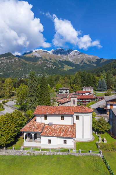 Aerial view of the Santuario di Lantana church and the Presolana covered in snow in autumn. Castione della Presolana, Seriana Valley, Bergamo province, Lombardy, Italy.