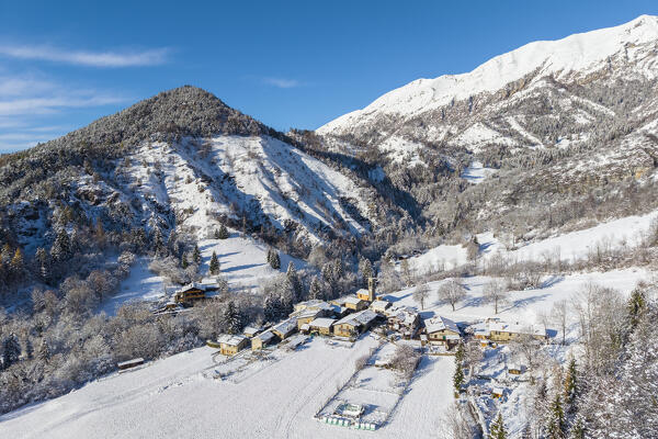 Aerial view of the small town of Rusio in Castione della Presolana after a snowfall in winter. Val Seriana, Bergamo district, Lombardy, Italy.