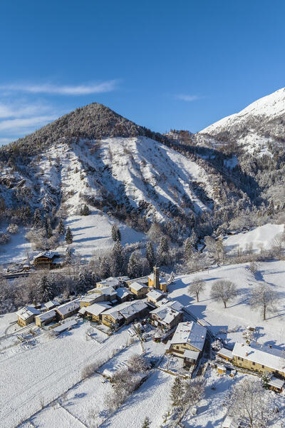 Aerial view of the small town of Rusio in Castione della Presolana after a snowfall in winter. Val Seriana, Bergamo district, Lombardy, Italy.