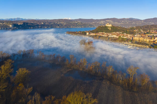 Aerial view of the fortress called Rocca di Angera during a winter sunrise with Monte Rosa in the background. Taino, Lake Maggiore, Varese district, Lombardy, Italy.